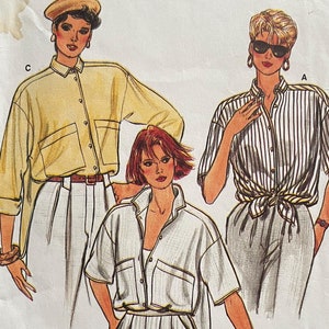 May include: A vintage sewing pattern titled "Very Easy Very Vogue" featuring illustrations of three different shirt and pants outfits. The pattern number is 9325, and the size range is 8-12. The outfits include a yellow shirt, a striped shirt, and a white shirt.