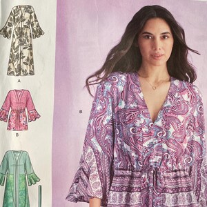 May include: Simplicity sewing pattern S9602. The pattern shows a woman in a paisley print dress with long sleeves and a drawstring waist. Other dress styles are illustrated. The size range is U.S. 16-24, Euro 42-50, and French 44-52.
