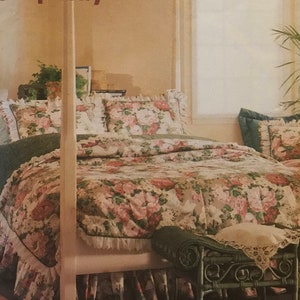 May include: A floral patterned bedspread with a white ruffle trim, a white headboard, and a wicker footstool. The bedspread is on a bed with two pillows. The image is from a Simplicity pattern for easy basics.