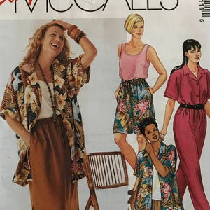 May include: A sewing pattern for a women's top and pants. The pattern is for sizes 18W, 20W, 22W, 36, 38, and 40. The pattern is called "Easy McCall's" and the number is 2211.