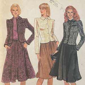 May include: A vintage Vogue sewing pattern featuring three women wearing different outfits. The pattern is for size 12 and costs £6.00. The women are wearing a purple skirt and jacket, a brown skirt and jacket, and a black skirt and jacket.