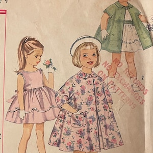 May include: Vintage Simplicity sewing pattern for a child's dress and coat. The pattern is for size 4 and is printed on a cream-colored paper with a floral design. The pattern includes instructions for making a dress with a scalloped hem and a coat with a Peter Pan collar.