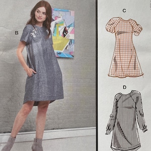 May include: McCall's sewing pattern M7862 featuring multiple dress designs. The pattern includes a photo of a woman wearing a gray dress. The pattern also shows illustrations of two other dress styles. The text "#AdaMcCalls" is visible.
