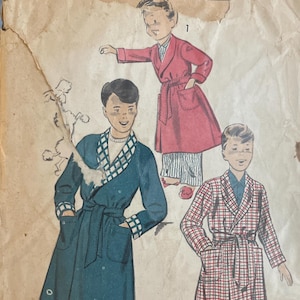 May include: Vintage sewing pattern for children's robes. The pattern envelope is tan and shows illustrations of three different robe designs. The text "ADVANCE PRINTED PATTERN" is visible at the top. The size is marked as "SMALL".