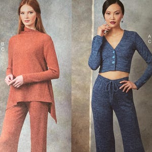 May include: Vogue Patterns sewing pattern featuring two women's outfits. One outfit is a rust-colored top and wide-leg pants. The other is a blue cropped cardigan and matching pants. The pattern includes sizes XSM-MED.