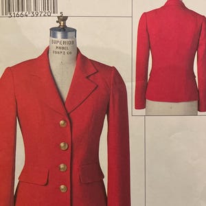 May include: A red blazer sewing pattern, V8087, from Claire Shaeffer's Custom Couture Collection. The pattern includes a front and back view of the blazer, with gold buttons and a classic design. The pattern size is FW (18-20-22).