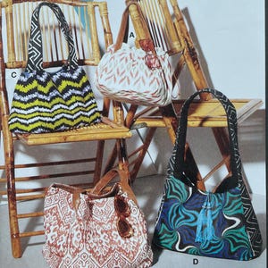 May include: McCall's sewing pattern featuring four different tote bag designs. The bags have various patterns, including zigzags, floral prints, and abstract designs. The pattern includes the text "McCall's" and "Designed and printed in USA."
