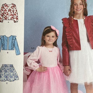 May include: Simplicity sewing pattern R12185 for girls' clothing. The pattern includes designs for a jacket, skirt, and dress. The image shows two girls wearing outfits made from the pattern. The pattern is designed and printed in the USA.