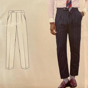 May include: Simplicity sewing pattern S9043. The pattern includes a drawing of pleated trousers. The image also shows a person wearing a pink striped shirt, a striped tie, and navy blue pinstripe trousers. The pattern size is U.S. 44-52.