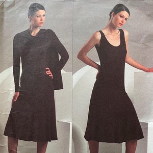 May include: A vintage sewing pattern for a black dress with a sleeveless design and a skirt that falls to the knee. The pattern is from the Donna Karan Collection, Vogue American Designer.