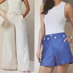 May include: Vogue Patterns sewing pattern featuring two outfits. One outfit includes wide-leg, cream-colored pants with large buttons. The other outfit includes blue shorts with white buttons. The pattern number is V2034.