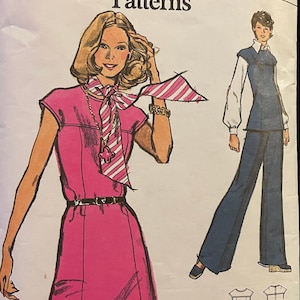 May include: A vintage sewing pattern for a dress and trousers. The pattern is for size 12, bust 34. The dress is pink and sleeveless. The trousers are blue and wide-legged. The pattern is from Very Easy Vogue Patterns.