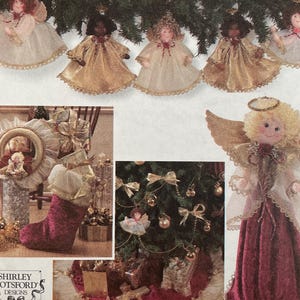 May include: Simplicity Holiday pattern collection with angel ornaments and Christmas tree decorations. The pattern includes instructions for making various festive crafts, including angel dolls, tree skirts, and stockings. The cover showcases finished projects in gold, red, and white.
