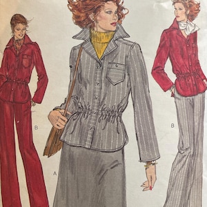 May include: A white ceramic mug with a black handle and the text "But First, Coffee" in a handwritten style. The mug is on a white surface. The mug is approximately 4 inches tall.