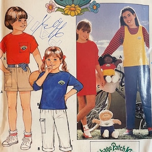 May include: Vintage Butterick sewing pattern for Cabbage Patch Kids outfits, sizes 4-5-6. The cover features illustrations of children in various outfits, with the Cabbage Patch Kids logo and text. Includes a bonus iron-on transfer.