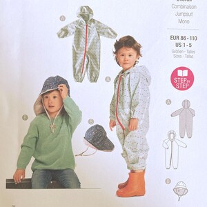 May include: A Burda Kids sewing pattern envelope 9279 for a hooded jumpsuit and hat. The white paper package displays illustrations and photographs of the garments, including a light-coloured jumpsuit with a red zip and a patterned sun hat.