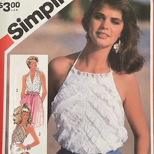 May include: Simplicity sewing pattern 5997, size 16 Miss. The cover features a woman wearing a white halter top and blue skirt. The pattern includes illustrations of different halter top designs. The price is $3.00.
