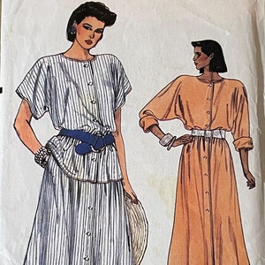May include: A sewing pattern for a dress with a striped skirt and a solid top. The pattern is for sizes 6-8-10. The pattern is called "Very Easy Very Vogue" and the pattern number is 9208.