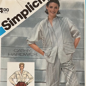 May include: Simplicity sewing pattern number 6442 for a striped shirt and pants. The pattern is for misses sizes. The model is wearing a white and gray striped shirt with a white collar and a pair of white and gray striped pants.