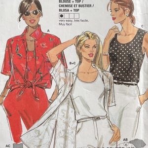 May include: A vintage Burda Super Easy sewing pattern for blouses and tops. The pattern features illustrations of three different blouse and top designs. The packaging is white with red, black, and green text and graphics. The pattern includes sizes 10-20.
