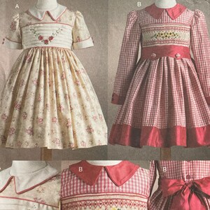 May include: A vintage sewing pattern for children's dresses. The pattern features two dress designs, one with a floral print and the other with a red and white gingham pattern. The pattern includes the text "V7958" and "Teresa Layman".