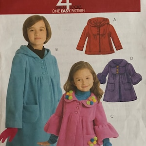 May include: A sewing pattern for a child's coat. The pattern includes four different styles: a red coat with a hood, a blue coat with a hood, a pink coat with a ruffled collar, and a purple coat with a hood. The pattern is for sizes 3-4-5-6. The pattern is called McCall's M5743.