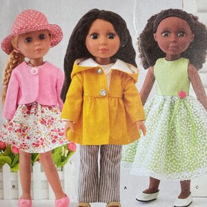 May include: Simplicity pattern S9378 featuring doll clothes. The pattern includes outfits for dolls, with measurements of 14 inches or 35.5 cm. The image shows three dolls wearing different outfits: a pink ensemble, a yellow coat with striped pants, and a green dress.