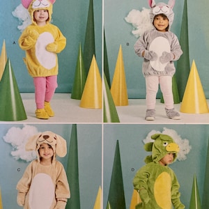 May include: Simplicity Costumes pattern S9624 featuring four children's animal costumes: a cat, a bunny, a dog, and a dragon. The costumes are shown in various colors, including yellow, gray, tan, and green. The pattern is designed and printed in the USA.