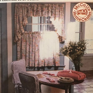 May include: McCall's Home Decorating pattern 8605 for kitchen essentials, featuring a window with a floral patterned valance, a dining table with a red and white checkered tablecloth, and a chair with a floral patterned seat cover.