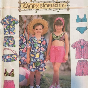 May include: Simplicity sewing pattern 7619 for children's clothing. The pattern includes a pink and blue patterned shirt and shorts, a pink and white patterned shirt and shorts, and a pink and white bikini top and bottom. The pattern is for sizes 5, 6, 7, and 8.