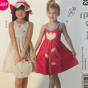 May include: McCall's MP403 sewing pattern for girls' dresses. The cover features two young girls modeling the dresses. One dress is striped, and the other is red with white polka dots and a flower design. The pattern size is CF (4-5-6).