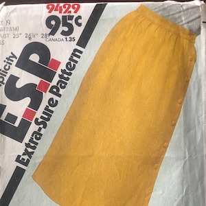 May include: A yellow skirt sewing pattern with a button-up front and a side slit. The pattern is labeled "Extra-Sure Pattern" and has the number 9429 on it. The price is 95 cents.