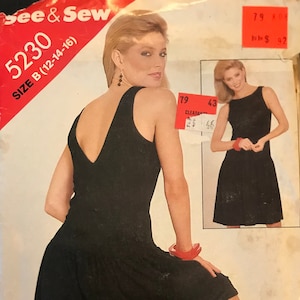 May include: A black sleeveless dress with a deep V-back and a flared skirt. The dress is shown on a model with red bracelets and red heels. The pattern number is 5230, size B (12-14-16).