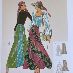 May include: A Burda Style 6965 sewing pattern envelope for a skirt. The illustration shows two long skirts, one green with polka dots and one black with floral patterns, worn with tops. Includes text labels A and B, size range US 10-20, and instructions.