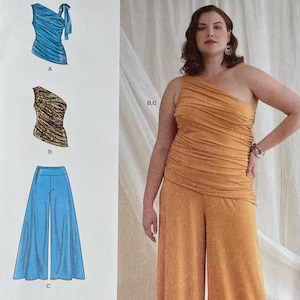 Peut inclure: Patron de couture Simplicity S9790 avec une femme en haut asymétrique orange et un pantalon large. Le patron comprend des modèles de hauts, de pantalons et d'une jupe. La gamme de tailles est U.S. 20W-28W, Euro 46-54, et FR 48-56.