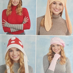 May include: Simplicity sewing pattern S9871 featuring four hat designs: a hooded hat, bunny ears hat, mushroom hat, and beret. The pattern includes sizes S-L and is designed and printed in the USA.