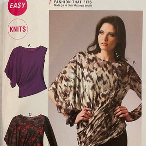 May include: A sewing pattern for a knit top with a draped neckline. The pattern is for sizes X-Small, Small, and Medium. The pattern is from McCall's and is called "Fashion That Fits".
