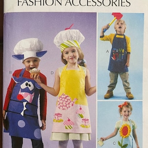 May include: A sewing pattern for kids' aprons. The pattern includes three different apron designs: a blue apron with a cow face, a pink and yellow apron with a teapot and cupcakes, and a blue apron with a sunflower. The pattern is for sizes 3-4, 5-6, 7-8. The pattern is from McCall's.