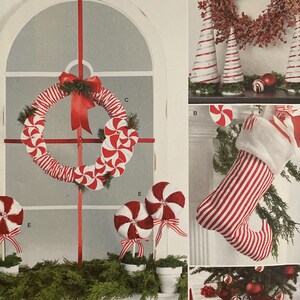 May include: Simplicity sewing pattern S9668 with Christmas decorations. The image displays a candy cane wreath, peppermint swirl ornaments, a stocking, and a tree skirt. The pattern includes instructions for easy-to-sew festive decor.