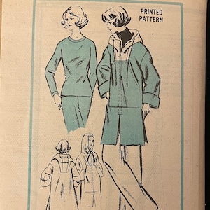 May include: Vintage sewing pattern envelope featuring a woman wearing a blue jacket and pants, and another woman wearing a blue top and pants. The pattern is by Gloria Vanderbilt, a prominent designer, and is size 10. The pattern number is A609.