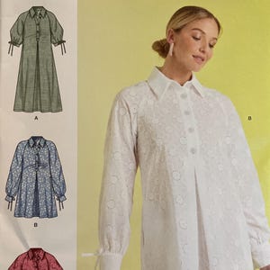 May include: Simplicity sewing pattern S9744, featuring three dress designs. The pattern includes sizes 18-26. The cover shows a woman wearing a white eyelet dress. The pattern is designed and printed in the USA.