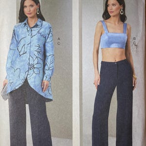 May include: Vogue Patterns sewing pattern featuring two outfits: a long-sleeved blue floral shirt with wide-leg pants, and a crop top with wide-leg pants. The pattern includes sizes B5 (8-10-12-14-16). The Vogue Patterns logo is at the top.