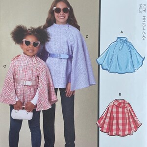 May include: McCall's M8538 sewing pattern envelope featuring illustrations and photographs of capes in sizes HH (3-4-5-6). The pattern displays three variations of capes, including a red plaid design, a solid blue design, and a pink tweed design.