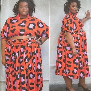 May include: A Simplicity sewing pattern envelope featuring a woman wearing a matching two-piece outfit. The outfit is a vibrant orange with black and purple leopard print. The envelope includes the pattern number 59551 and the text "easy-to-sew".