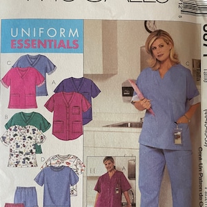 May include: A sewing pattern for a uniform top and trousers. The pattern is for sizes KK (26W-28W-30W-32W) and includes instructions for making a scrub top and trousers. The pattern is from McCall's and is called "Uniform Essentials".