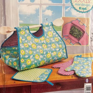 May include: A sewing pattern titled "Potluck Party" featuring a quilted tote bag, oven mitt, and pot holder. The tote bag is turquoise with yellow floral accents. The pattern is by "ellie mae designs."