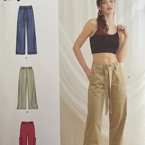 May include: Simplicity sewing pattern S9785, featuring three different styles of wide-leg pants. The pattern includes sizes U.S. 8-16. The image shows a woman wearing a pair of khaki-colored pants. The text "easy-to-sew" is visible.