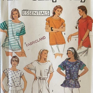 May include: Simplicity sewing pattern 7171, featuring various women's tops. The pattern includes designs for a striped tee, an orange top, a red hooded shirt, a polka dot top, a white top with lace sleeves, and a floral top. The text "easy essentials" is visible.