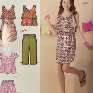 May include: Simplicity sewing pattern featuring various clothing designs, including a dress, top, and shorts. The pattern includes the text "PREPPY", "COOL", and "GIRLY". The pattern is labeled "1625 BB" and includes the text "SUEDE says".