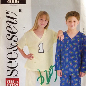 May include: A sewing pattern for a boy's and girl's pajama set. The pattern includes a long-sleeved shirt and pants for the boy and a short-sleeved shirt and pants for the girl. The boy's shirt has a blue and white pattern with traffic lights. The girl's shirt is yellow with a large number "1" on the front. The pattern is from the brand "see&sew" and has the number "4006" on it.